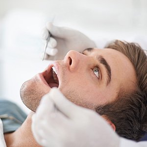 man getting examined for gum disease