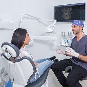 a dentist speaking with a patient