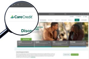 a magnifying glass hovering over the carecredit logo on a webpage