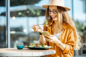 Smiling woman eating a salad 