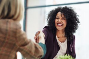 smiling professional woman shaking hands